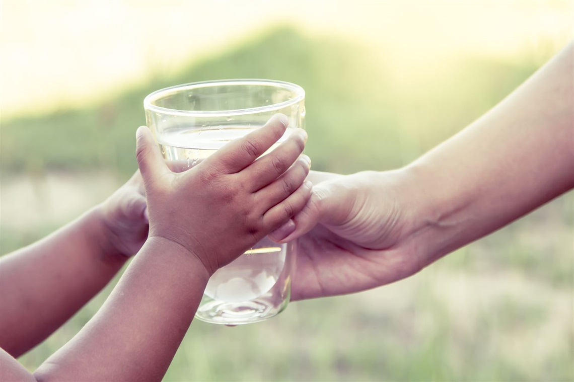 Hands holding water glass.jpg